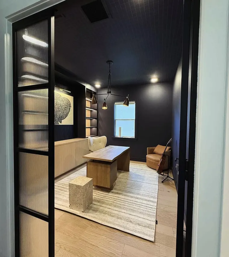 Home office behind steel-frame glass doors