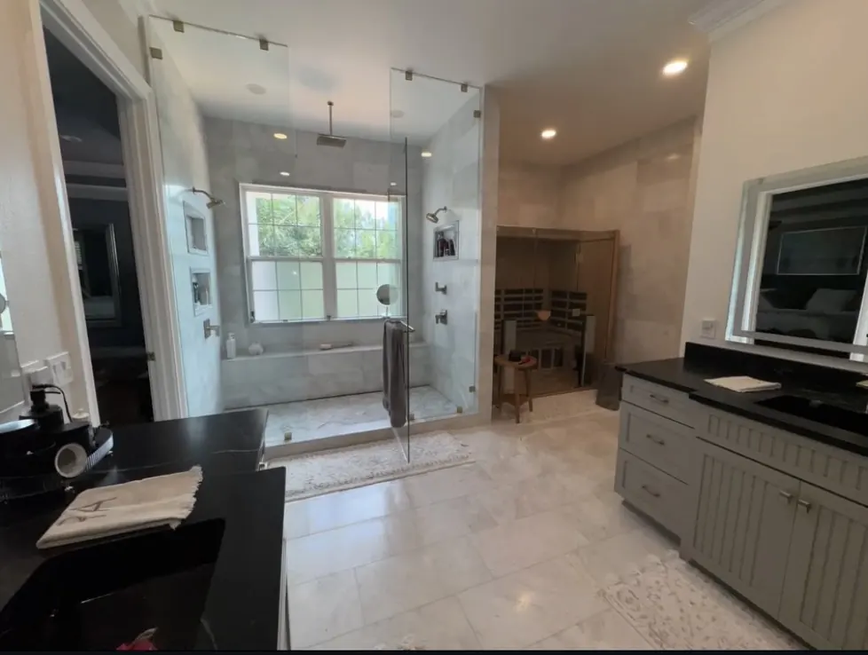 Primary bath with frameless glass shower by CWL Construction